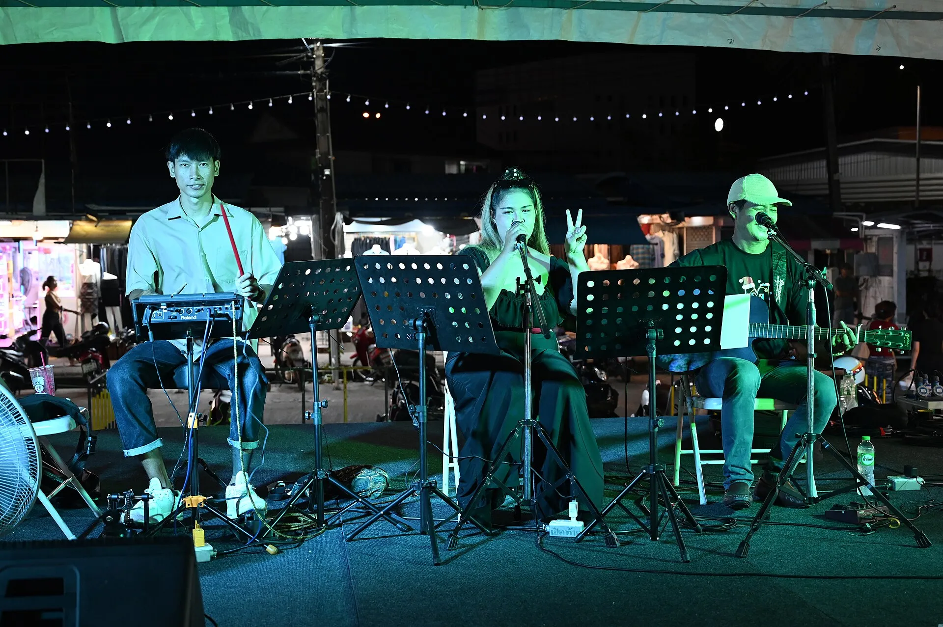 singer performing with microphone stage lights